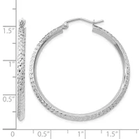 A pair of silver textured hoop earrings with measurement scale showing approximately 1.5 inches in length, displayed with one earring shown close-up on the left and both earrings shown together on the right.