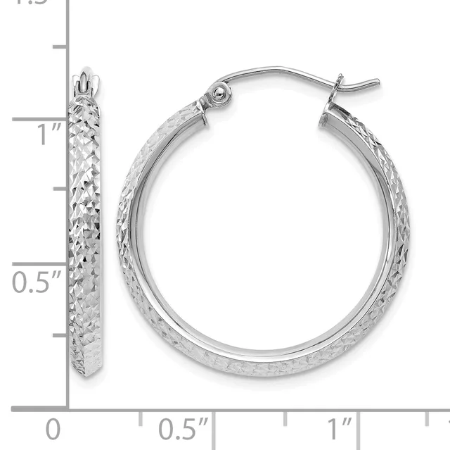 A pair of silver hoop earrings with a textured diamond-cut finish, shown next to a measurement ruler indicating they are approximately one inch in diameter.