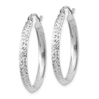 A pair of silver hoop earrings with a textured diamond-cut surface and polished inner edges, displayed against a white background.