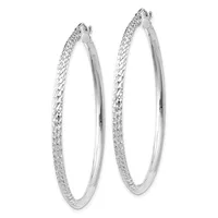 A pair of silver hoop earrings with a textured diamond-cut surface on the outer edge and smooth polished inner surface, shown from the front.