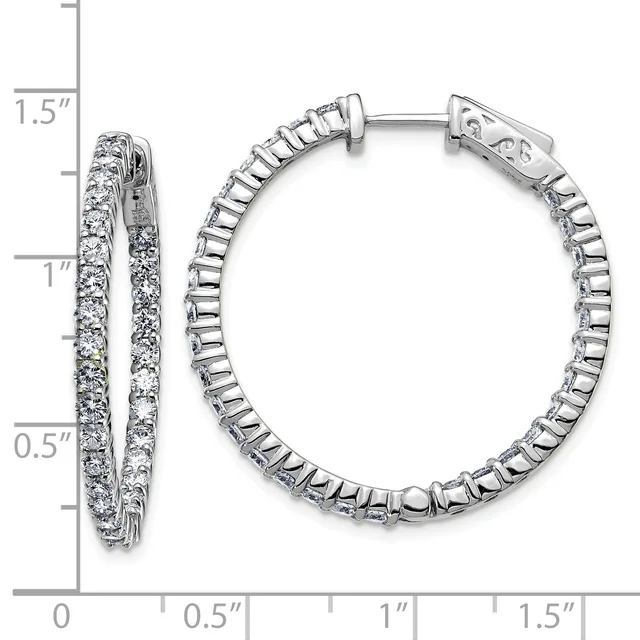 A pair of silver hoop earrings with diamond settings shown from front and side angles against a measurement scale.
