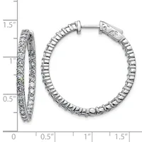 A pair of silver hoop earrings with diamond settings shown from front and side angles against a measurement scale.