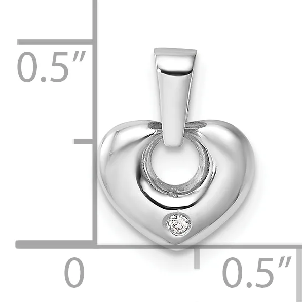 Silver heart-shaped pendant with a small round diamond accent, shown with a measurement scale indicating approximately 0.5 inches in height and width.