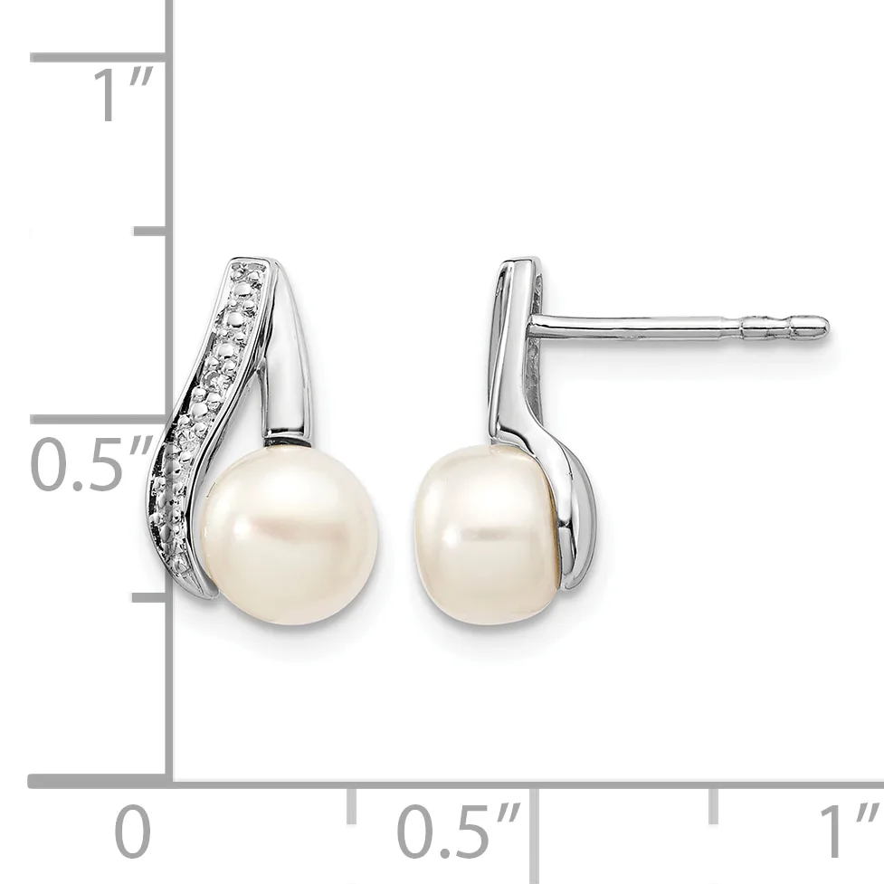 Pair of silver stud earrings featuring white pearls suspended below curved silver tops set with small diamonds, shown with a measurement scale.