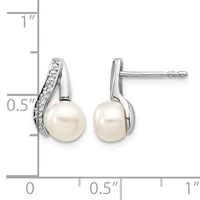 Pair of silver stud earrings featuring white pearls suspended below curved silver tops set with small diamonds, shown with a measurement scale.