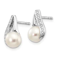 Pair of silver stud earrings with curved tops set with small diamonds and cream-colored pearl drops, shown from the front.