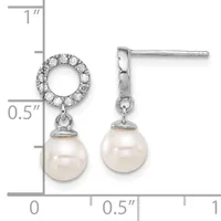 Silver drop earrings with diamond-studded circular tops and cream pearl pendants, shown with a measurement scale indicating approximately one inch in length.