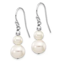 A pair of silver fishhook earrings, each featuring two graduated cream-colored pearl spheres suspended from a small faceted bead.