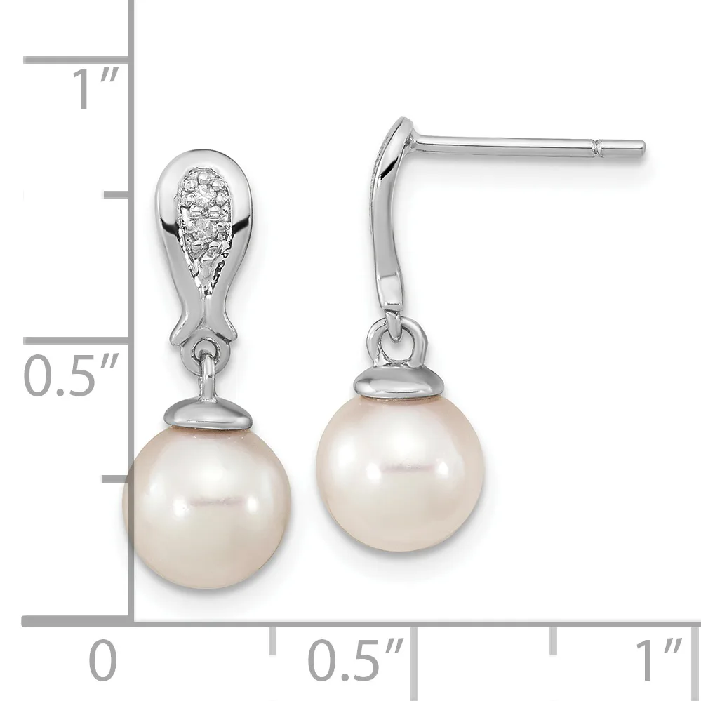 Pair of silver teardrop earrings with diamond-set tops and cream pearl drops, shown with measurement scale indicating approximately one inch in length.