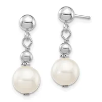 Pair of silver drop earrings with polished ball studs, heart-shaped connectors, smaller silver spheres, and large cream-colored pearl drops.