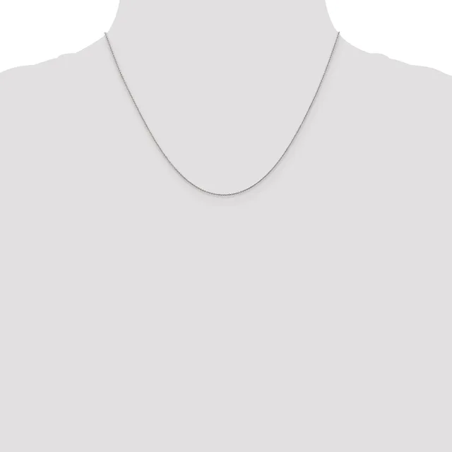 A thin silver chain necklace displayed on a mannequin torso against a neutral background.