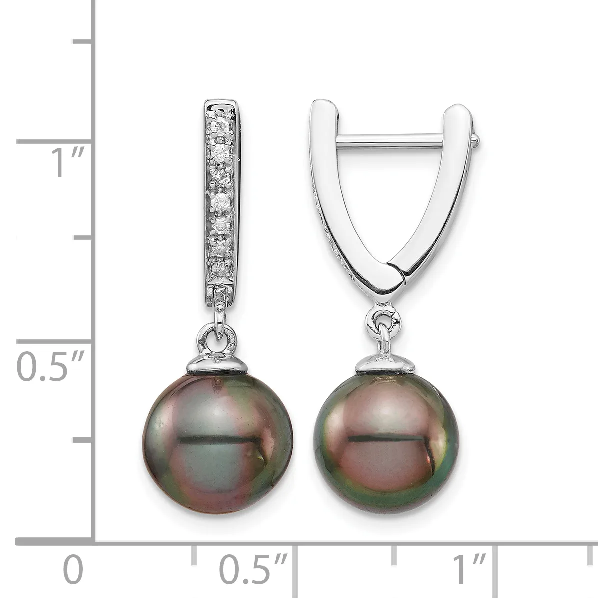 A pair of silver huggie earrings with diamond-set bails and dark tahitian pearl drops, shown next to a measurement scale indicating approximately one inch in length.