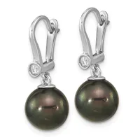 A pair of silver drop earrings with lever backs, each featuring a small round diamond above a dark green pearl.