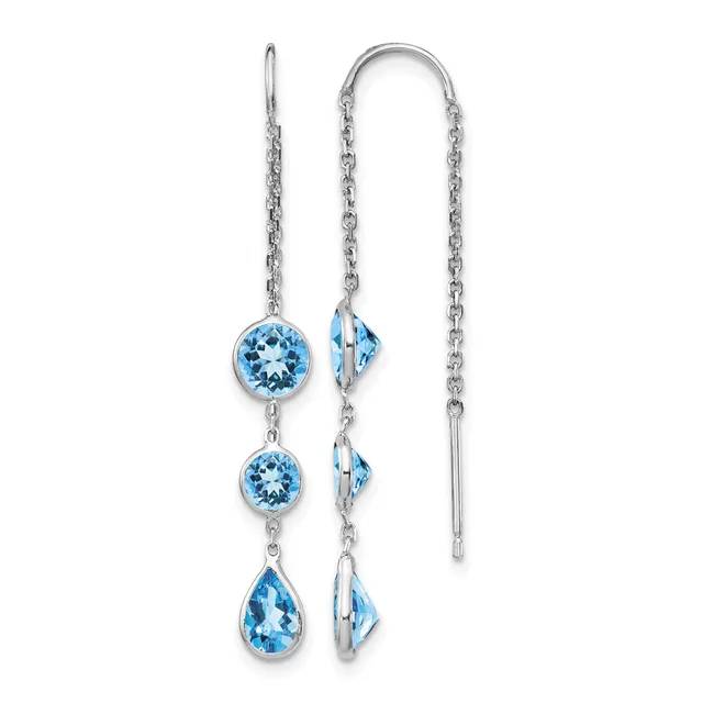 Pair of silver threader earrings with blue topaz gemstones in round and teardrop shapes suspended from delicate chains.