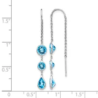 Silver threader earrings with blue topaz gemstones in round and teardrop shapes, displayed next to a measurement scale showing approximately 1.5 inches in length.