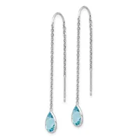 Pair of silver threader earrings with delicate chain strands and teardrop-shaped blue topaz gemstones suspended at the ends.