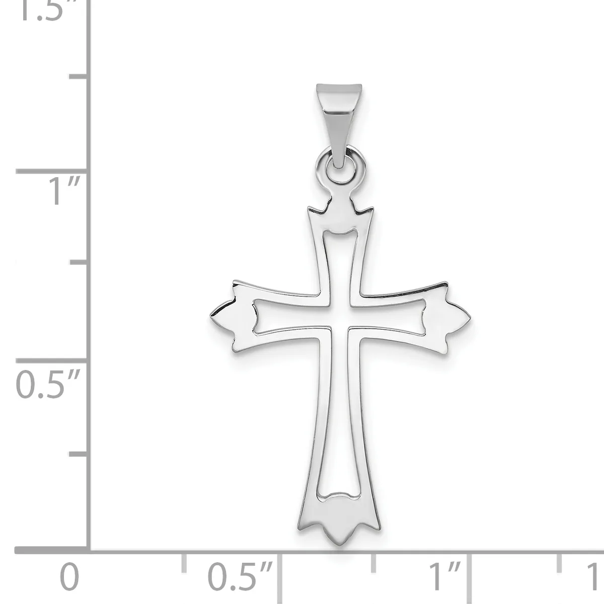 A silver cross pendant with ornate flared ends shown against a ruler measuring approximately 1.25 inches in height.