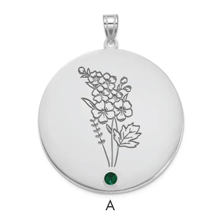Silver circular pendant with engraved botanical flower design and a small green gemstone at the bottom, suspended from a silver bail.