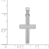 A polished silver cross pendant with textured vertical and horizontal bars, shown against a measurement scale indicating approximately one inch in height.