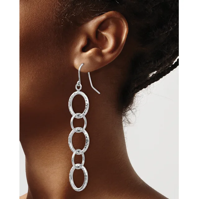 Silver-toned chain link dangle earrings with oval links hanging from curved ear wires, shown worn on a person's ear.