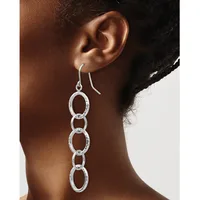 Silver-toned chain link dangle earrings with oval links hanging from curved ear wires, shown worn on a person's ear.