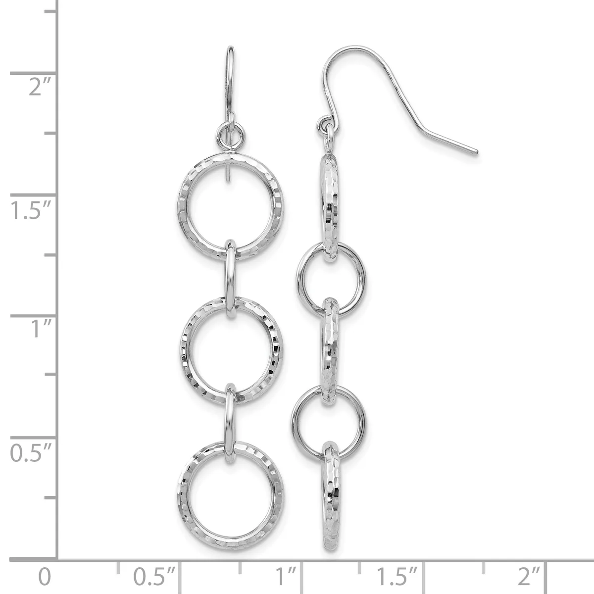 A pair of silver triple-circle dangle earrings with textured rings connected by bars, shown on a ruler measuring approximately two inches long.