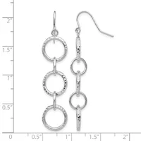 A pair of silver triple-circle dangle earrings with textured rings connected by bars, shown on a ruler measuring approximately two inches long.