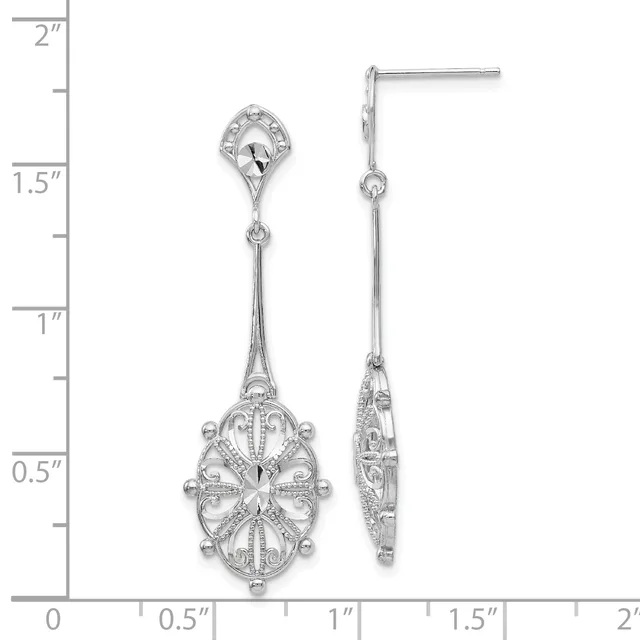 Pair of silver filigree drop earrings with ornate oval pendants hanging from small post tops, displayed against a ruler showing measurements up to 2 inches.