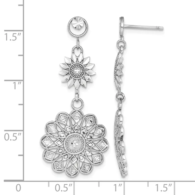 Silver dangle earrings featuring a sunflower design with textured petals and a dotted center, suspended from a bezel-set round stone stud, shown against a measurement ruler.