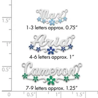 Three silver name pendants with decorative flowers shown at actual size against a ruler, ranging from 0.75 to 1.25 inches tall depending on letter count.