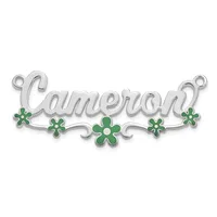 Silver pendant with the name Cameron in script lettering, decorated with green enamel four-petaled flowers and scrollwork, with small loops at each end for attachment.