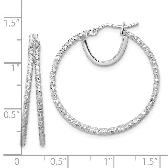 Silver textured hoop earrings displayed next to a ruler showing their size of approximately 1.5 inches in diameter.