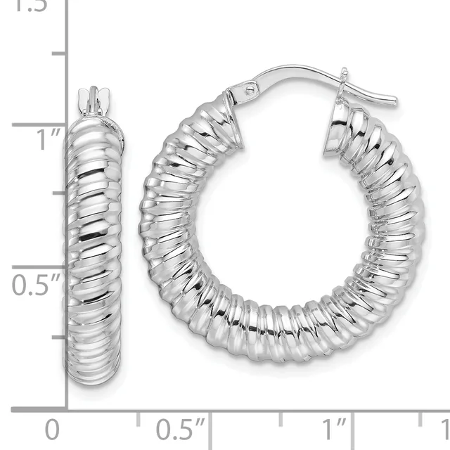 Pair of silver-toned twisted hoop earrings with toggle closures, displayed against a measurement ruler showing approximately one inch in diameter.