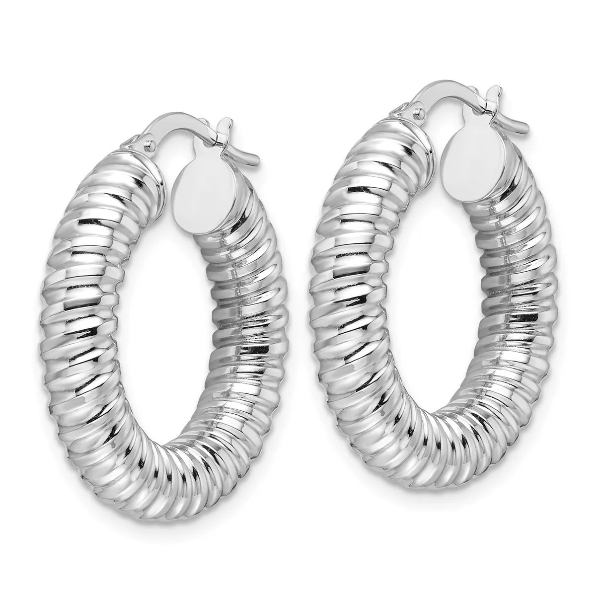 A pair of silver-toned textured hoop earrings with a ribbed surface pattern and hinged closures, displayed side by side.