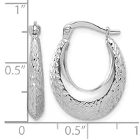 A pair of silver oval hoop earrings with textured surfaces, displayed against a measurement scale showing approximately one inch in height and half inch in width.