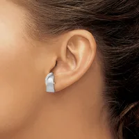 A silver chunky curved hoop earring worn on a person's ear, shown from a side profile view.