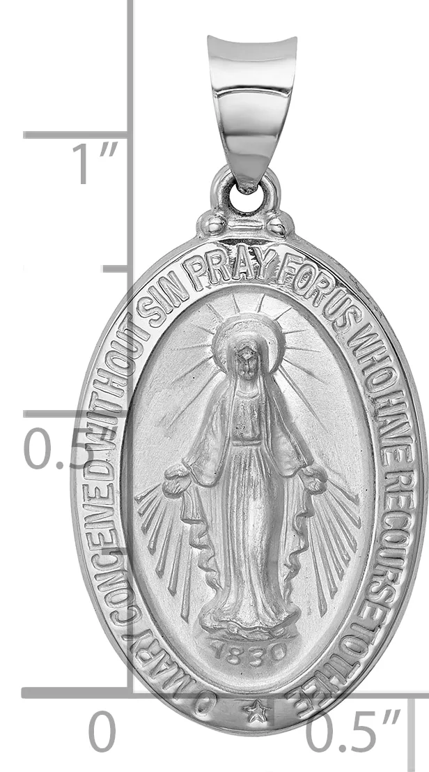 Silver oval religious medal pendant with image of robed figure with radiating halo, surrounded by text around border, with small stamped hallmark, shown with measurement scale.