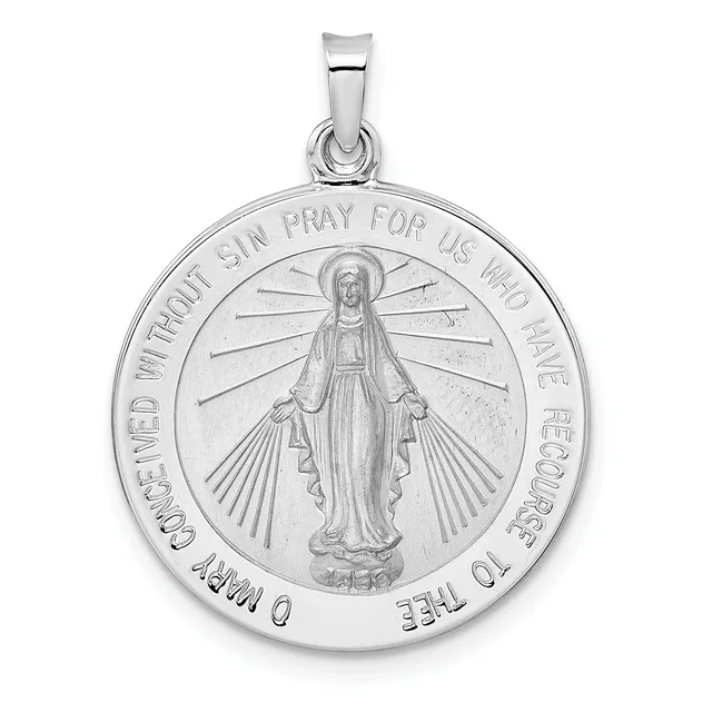 Silver pendant featuring a standing figure with a halo surrounded by radiating lines, with text around the circular border and a small bail loop at the top.