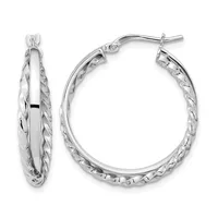 A pair of silver-toned hoop earrings with twisted textured outer surfaces and smooth polished inner surfaces, shown from front and side angles.