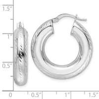 A pair of silver hoop earrings with a twisted texture pattern, displayed next to a measurement scale showing they are approximately one inch in diameter.