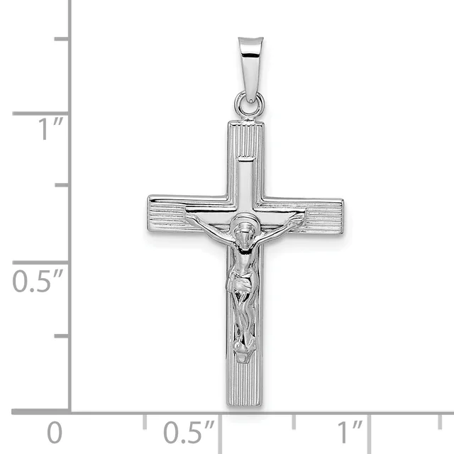 Sterling silver crucifix pendant with textured cross arms and a polished corpus figure, shown with measurement scale indicating approximately one inch in height.