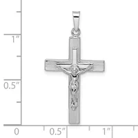 Sterling silver crucifix pendant with textured cross arms and a polished corpus figure, shown with measurement scale indicating approximately one inch in height.