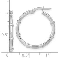 Pair of polished silver-toned hoop earrings with decorative bamboo-style segmented texture, shown with a measurement scale indicating approximately one inch in diameter.