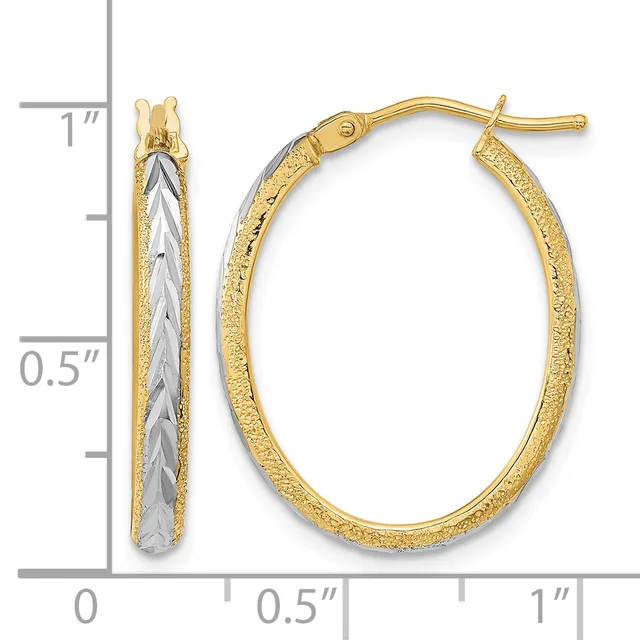 Pair of two-tone gold hoop earrings with textured outer surface and smooth inner surface, shown next to a ruler for scale.