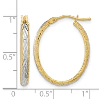 Pair of two-tone gold hoop earrings with textured outer surface and smooth inner surface, shown next to a ruler for scale.