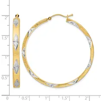 A pair of two-tone gold hoop earrings with textured surfaces and diamond-shaped white metal accents, shown next to a measurement ruler indicating approximately 1.75 inches in diameter.