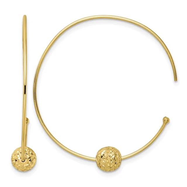 Gold-toned open bangle bracelet with textured spherical ball ends, shown with a matching curved hook earring against a white background.