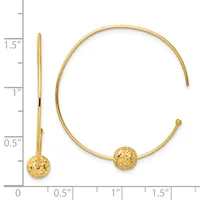 Gold-colored cuff bracelet with textured spherical ends, shown open with a measurement scale indicating approximately 1.5 inches in length.