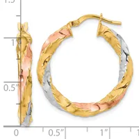 Pair of tricolor gold hoop earrings with textured surface and post backs, displayed against a measurement scale.