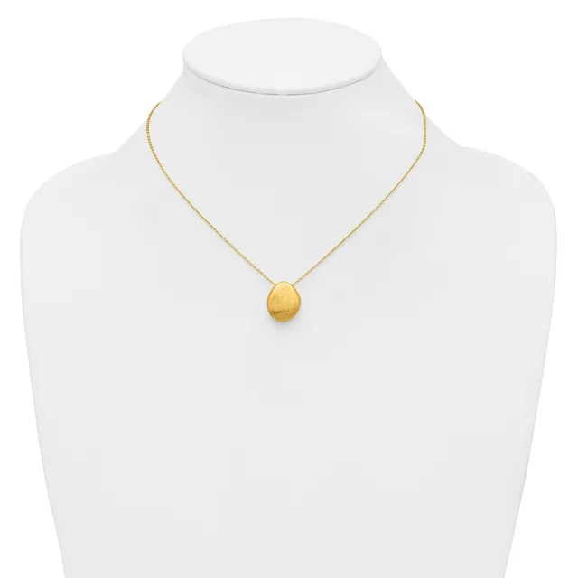 A gold chain necklace with a small brushed gold oval pendant displayed on a white mannequin bust.